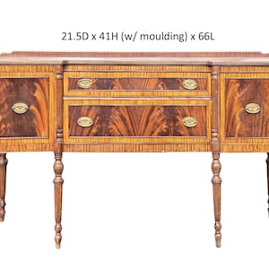 May include: A wooden sideboard with a mahogany finish and brass hardware. It has four drawers and two doors. The sideboard is 21.5 inches deep, 41 inches high (including the molding), and 66 inches long.