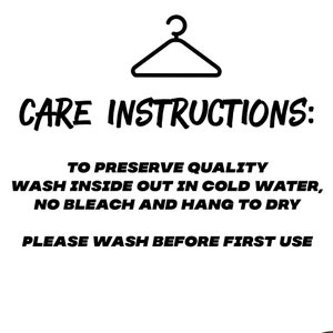 May include: Black and white care instructions for a garment. The instructions include washing inside out in cold water, no bleach, and hanging to dry. The text also states to please wash before first use.