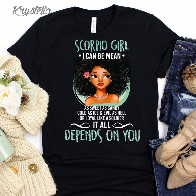 May include: Black t-shirt with a green and white graphic design featuring a cartoon illustration of a woman with an afro. The text reads "Scorpio Girl &bull; I can be mean &bull; As sweet as candy cold as ice & evil as hell or loyal like a soldier It all depends on you".
