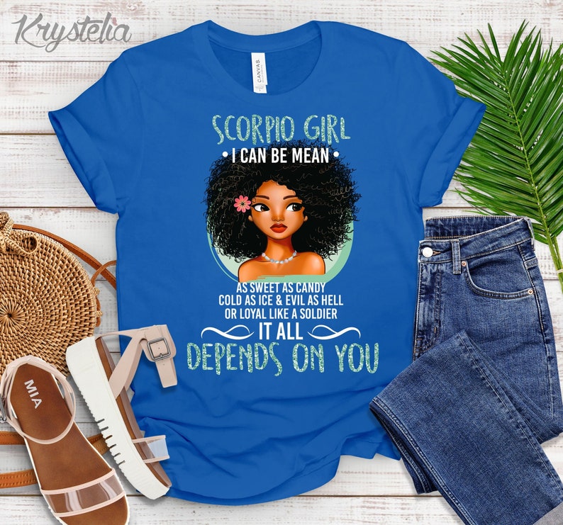 May include: Blue t-shirt with a graphic of a black woman with an afro and the text "Scorpio Girl &bull; I can be mean &bull; As sweet as candy cold as ice & evil as hell or loyal like a soldier It all depends on you"