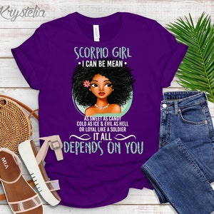 May include: Purple t-shirt with a graphic of a Black woman with an afro and the text "Scorpio Girl &bull; I can be mean &bull; As sweet as candy cold as ice & evil as hell or loyal like a soldier It all depends on you"
