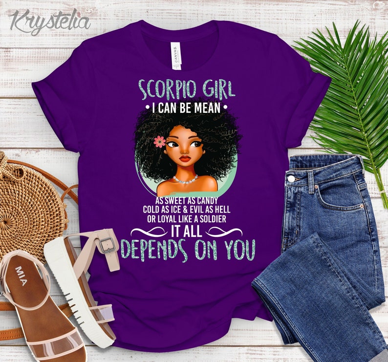 May include: Purple t-shirt with a graphic of a Black woman with an afro and the text "Scorpio Girl &bull; I can be mean &bull; As sweet as candy cold as ice & evil as hell or loyal like a soldier It all depends on you"