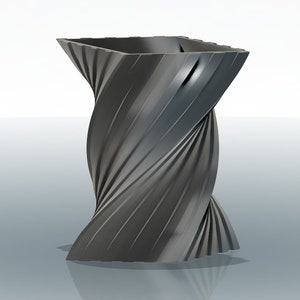 Può includere: Un vaso nero contorto con un'apertura quadrata nella parte superiore. Il vaso è fatto di un materiale liscio e lucido e ha una superficie riflettente.