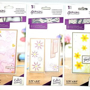 May include: Three packages of Gemini die cuts for card making. Each package contains one die cut with a different design: pink hearts, pink flowers, and yellow flowers. The die cuts are 3.75 inches by 8.5 inches.