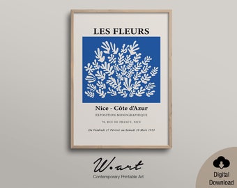 May include: A printable art print featuring a blue background with white stylized leaves. The text "LES FLEURS" is at the top of the print. The text "Nice - Côte d'Azur" is in the middle of the print. The text "EXPOSITION MONOGRAPHIQUE" is below the text "Nice - Côte d'Azur". The text "70, RUE DE FRANCE, NICE" is below the text "EXPOSITION MONOGRAPHIQUE". The text "Du Vendredi 27 Février au Samedi 28 Mars 1953" is below the text "70, RUE DE FRANCE, NICE". The text "Woart" is at the bottom of the print. The text "Contemporary Printable Art" is below the text "Woart".