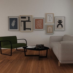May include: A living room interior with a green armchair, a gray sofa, a black coffee table, and a gallery wall of six framed abstract art prints. The prints feature black and white line drawings, geometric shapes, and organic forms.