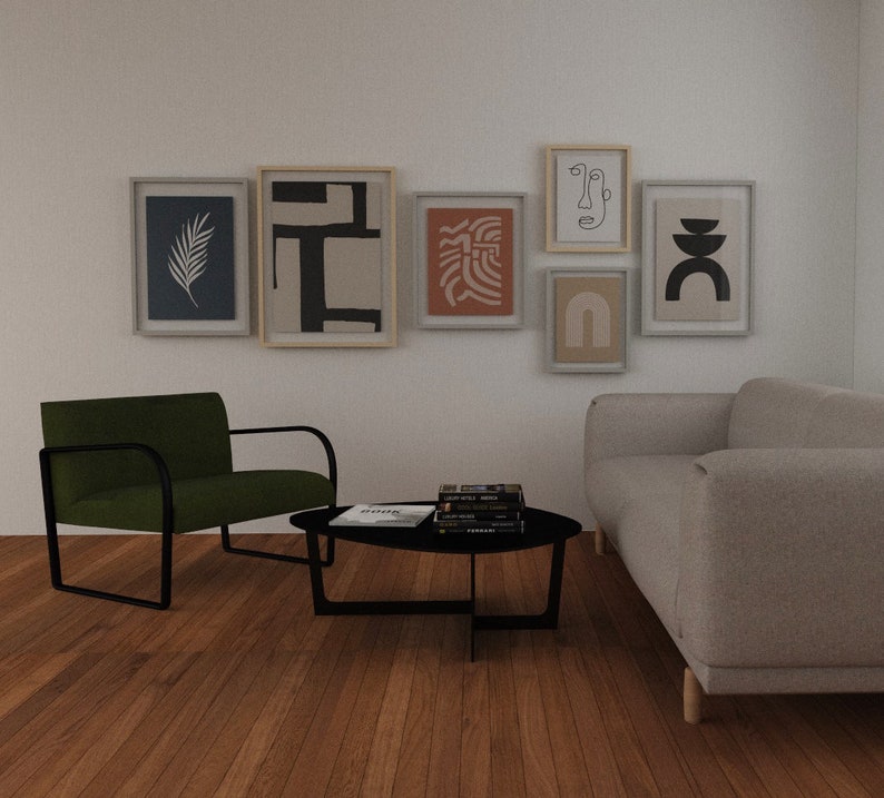 May include: A living room interior with a green armchair, a gray sofa, a black coffee table, and a gallery wall of six framed abstract art prints. The prints feature black and white line drawings, geometric shapes, and organic forms.