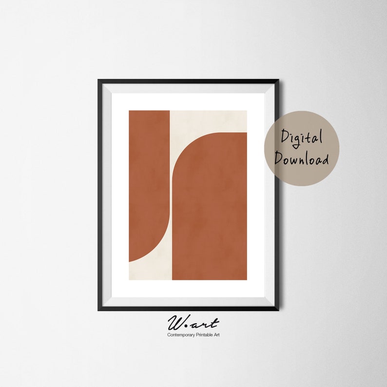 May include: Abstract geometric art print with a brown and cream color scheme. The print features two overlapping shapes, one a rectangle and the other a curved shape. The print is framed in a black frame.