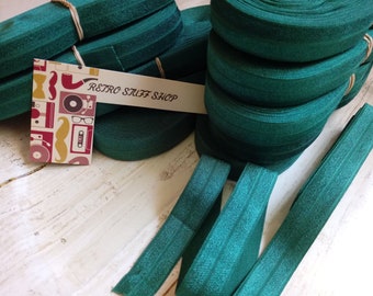 May include: A stack of teal elastic ribbon with a tag that says "Retro Stuff Shop".