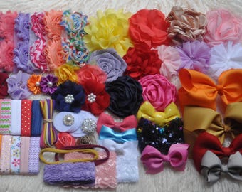 May include: A collection of colorful hair accessories, including headbands, bows, and flower embellishments. The assortment features a variety of colors, textures, and patterns, suitable for various occasions. The accessories are arranged on a soft, white surface.