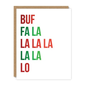 May include: A white greeting card with the text "BUF FA LA LA LA LA LA LO" in red and green letters. The card has a brown border.