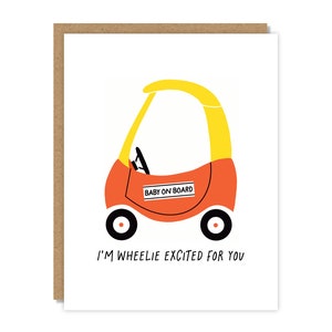 May include: A red and yellow toy car with a "Baby on Board" sign. The card reads "I'm wheelie excited for you".
