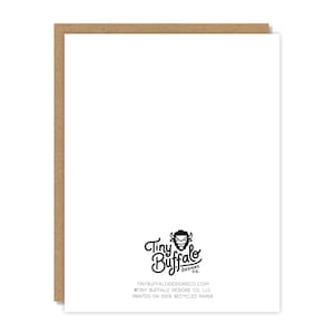 May include: A white greeting card with a brown border. The card features the Tiny Buffalo Designs Co. logo and text at the bottom. The text reads: TINYBUFFALODESIGNSCO.COM, &copy;TINY BUFFALO DESIGNS CO. LLC, PRINTED ON 100% RECYCLED PAPER.