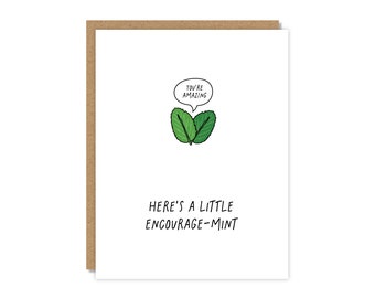 May include: A white card with a green mint leaf illustration and the text "You're amazing" in a speech bubble above the leaves. Below the illustration is the text "Here's a little encourage-mint".