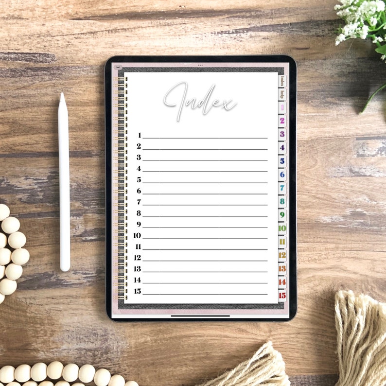 May include: A white digital tablet with a black frame and a white background. The screen displays a list of numbers 1 through 15 with a line next to each number. The word "Index" is written in cursive at the top of the screen.