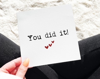 May include: A white card with the text "You did it!" in black font and three red hearts.