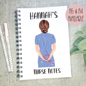 May include: A white spiral bound notebook with a blue and red illustration of a nurse with a stethoscope and the text "HANNAH'S NURSE NOTES" on the front.
