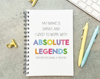 May include: A white notebook with a spiral binding. The notebook has a quote on it that reads "My name is Sarah, and I used to work with absolute legends (before becoming a traitor)". The words "absolute" and "legends" are in colourful letters.