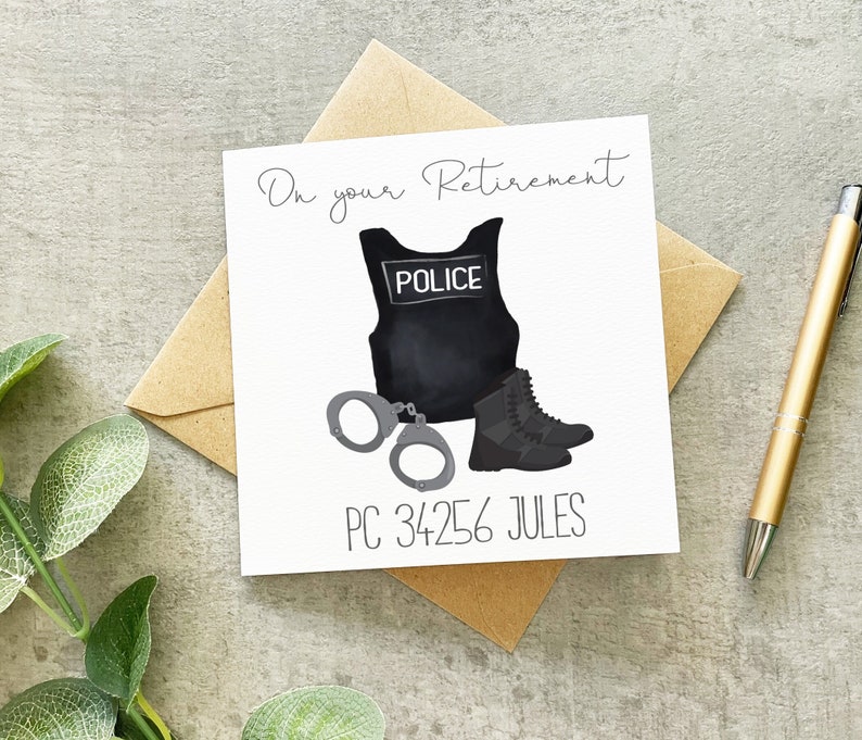 May include: A white card with a black and white illustration of a police officer's uniform, handcuffs, and boots. The text "On your Retirement" is at the top of the card. The text "PC 34256 JULES" is at the bottom of the card.