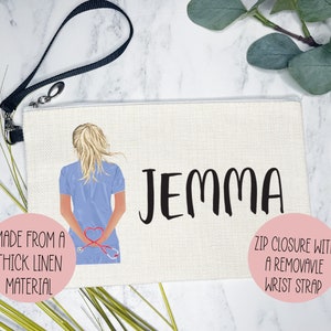 May include: A white canvas zippered pouch with a black wrist strap. The pouch features a cartoon illustration of a nurse with a stethoscope and the name "Jemma" printed in black. The pouch is made from a thick linen material.