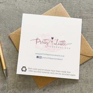 May include: A white card with a pink watercolor background and the text "Pretty Little Personalised" in black script. The card also includes a small black heart and the website address "www.prettylittlepersonalised.co.uk" in black text. The card is surrounded by a brown envelope.