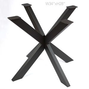 May include: Black metal table base with a starburst design. The base measures 34 inches wide and 28 inches high.