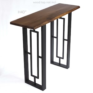May include: Black metal table legs with a geometric design. The legs are 40 inches tall.  wood top not incl.
