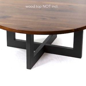 May include: A round coffee table with a dark wood top and black geometric base. The table is 16 inches high. The text "wood top NOT incl." is visible.