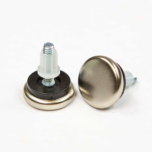 May include: Two silver-toned furniture feet with a rounded, cap-like design. Each foot has a threaded post for attachment, with a black rubber base and a clear plastic spacer. The feet are designed for furniture.