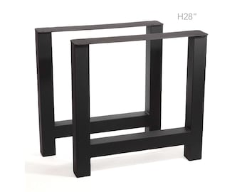 May include: Two black metal table legs, each with a rectangular frame design. The legs are 71 cm high, as indicated by the text in the image. The legs are designed to support a tabletop.