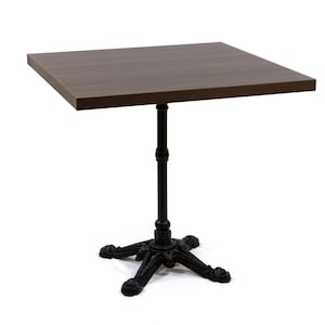 May include: A square-top table with a dark brown wooden surface. The table is supported by a black, ornate metal base and a central column. The table's dimensions are approximately 30 inches by 30 inches.