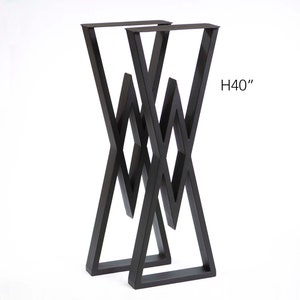 May include: A pair of black metal table legs with a geometric, X-shaped design. The legs are 40 inches tall.