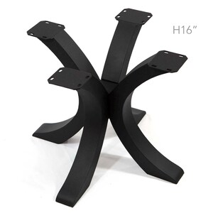 May include: Black metal table base with six curved legs. The base is 16 inches high and has mounting plates at the top of each leg. The design is modern and suitable for various table tops.