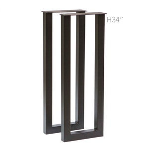 May include: Two black metal table legs, each with a rectangular shape and a height of 34 inches.  H34" is printed on the image.
