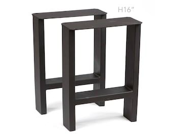 May include: Two black metal table legs, each with a rectangular top and a single crossbar, standing 16 inches tall.