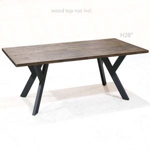 May include: A dark brown wooden table top with black metal X-shaped legs. The table is 28 inches tall. "wood top not incl." is written above the table.