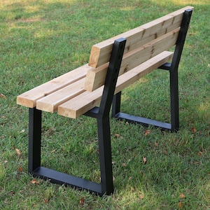 May include: A wooden bench with a black metal frame. The bench has a slatted seat and back.