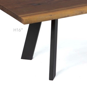 May include: A wooden table with a live edge top and black metal legs. The table is 16 inches (40.6 cm) tall.