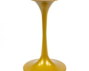May include: A gold metal table base with a round top and a slender, curved stem. The base is smooth and has a glossy finish.
