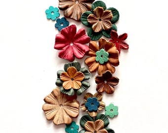 May include: Assortment of leather flower embellishments in various colors, including brown, red, green, and blue. The flowers are all different sizes and shapes, and they have a delicate, handcrafted look.