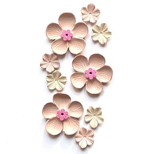 Peut inclure: Assortiment de fleurs en papier roses et dorées. Les fleurs sont superposées et ont un effet 3D. Les fleurs sont parfaites pour le scrapbooking, la fabrication de cartes et autres projets d'artisanat.