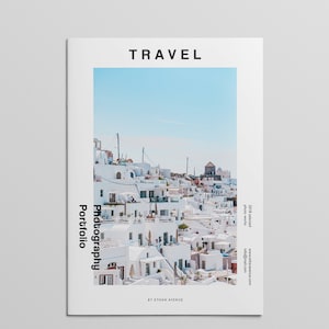 May include: A magazine cover with the title "TRAVEL Photography Portfolio" by Ethan Avenue. The cover features a photo of a white city with blue sky in the background.