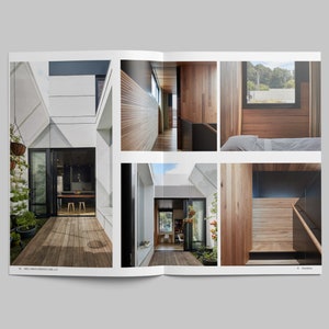 May include: A magazine spread showcasing a modern home with wooden walls and a patio with a wooden deck. The home features a large window with a view of the outdoors.