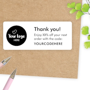 May include: White thank you card with a black circle containing a heart and the text "Your Logo Here". The card also includes the text "Thank you! Enjoy XX% off your next order with the code: YOURCODEHERE."