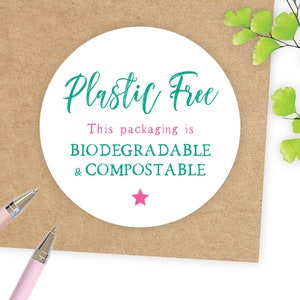 May include: White round sticker with the text "Plastic Free" in green cursive lettering. Below the text is "This packaging is BIODEGRADABLE & COMPOSTABLE" in green text. A pink star is below the text.