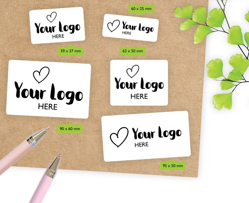 May include: Four white rectangular stickers with black text and a heart symbol. The text on the stickers reads "Your Logo Here". The stickers are different sizes: 2.36 x 0.98 inches, 2.48 x 1.97 inches, 3.54 x 2.36 inches, and 3.74 x 1.97 inches.