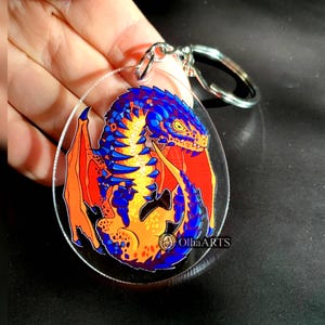 Llavero con huevo de dragón de lava — Dragón de fuego, llavero de fantasía, accesorio de acrílico transparente de doble cara