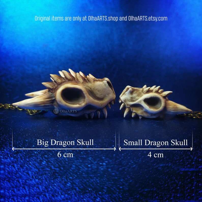 May include: Two ceramic dragon skulls, one large and one small, on a blue background. The large skull is 6 cm long and the small skull is 4 cm long.  Original items are only at OlhaARTS.shop and OlhaARTS.etsy.com