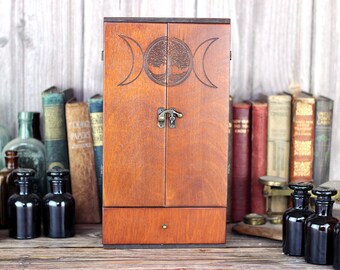 Triple Moon Goddess and Tree of Life engraved wooden apothecary cabinet with drawer and 6 brown medicine poison bottles with glass stoppers
