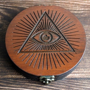 Seeing eye round obsidian scrying mirror in circular wooden case for spiritual divination,  engraving, 10cm round